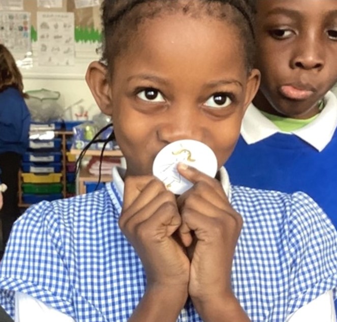 Young person with money badge they designed